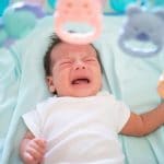 Photo of baby with colic crying