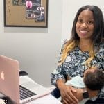 Mom breastfeeding baby at work photo