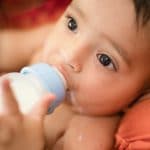 Photo of baby drinking bottle