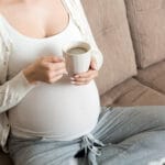 Photo of pregnant woman drinking coffee