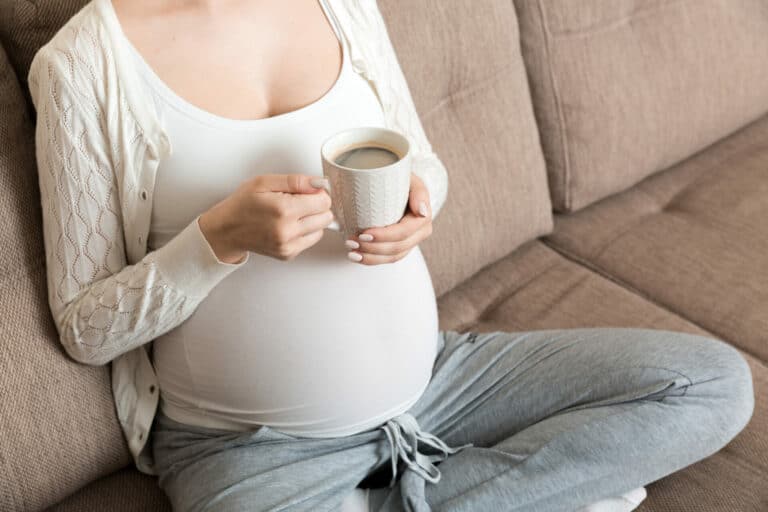Photo of pregnant woman drinking coffee