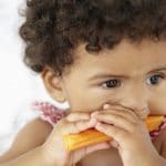 Photo of toddler eating vegetables